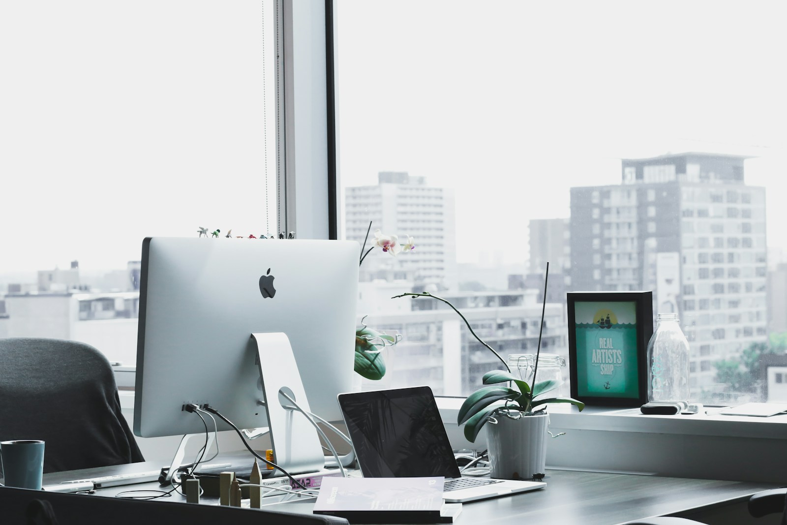 VisualForge AI studio in the evening with monitors displaying brand visual reviews